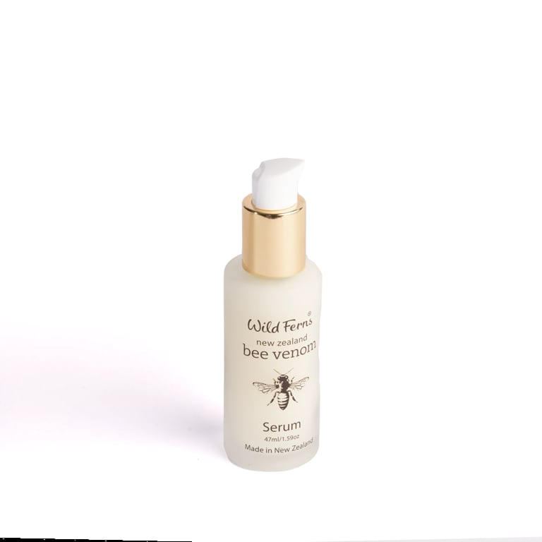 Wild Ferns bee venom serum bottle with gold pump dispenser on white background